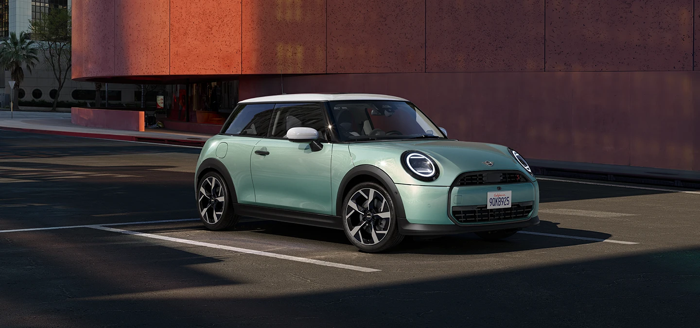 Πλαϊνή μπροστινή όψη του MINI Cooper σε χρώμα Ocean Wave Green και λευκή οροφή.