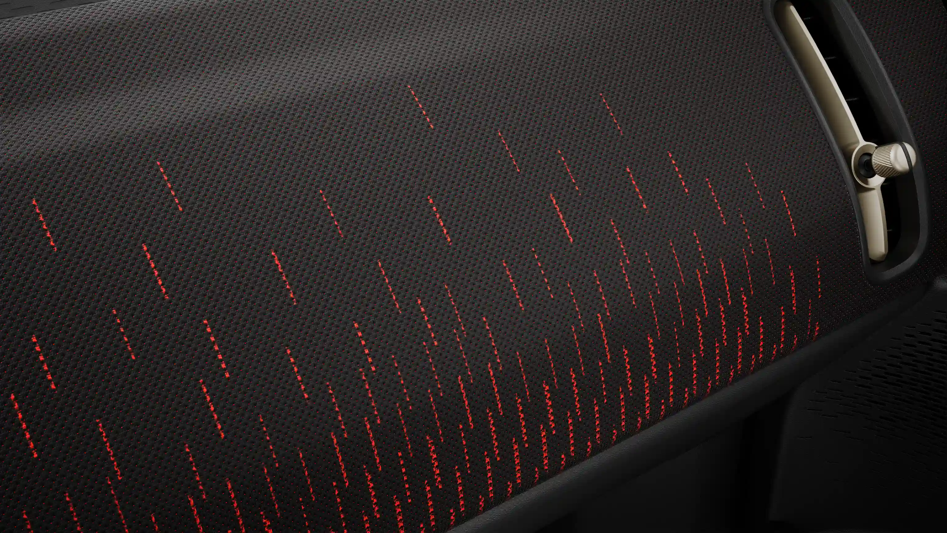 Άποψη από το ταμπλό σε στιλ JCW με κόκκινες και μαύρες λεπτομέρειες του αμιγώς ηλεκτρικού MINI Countryman