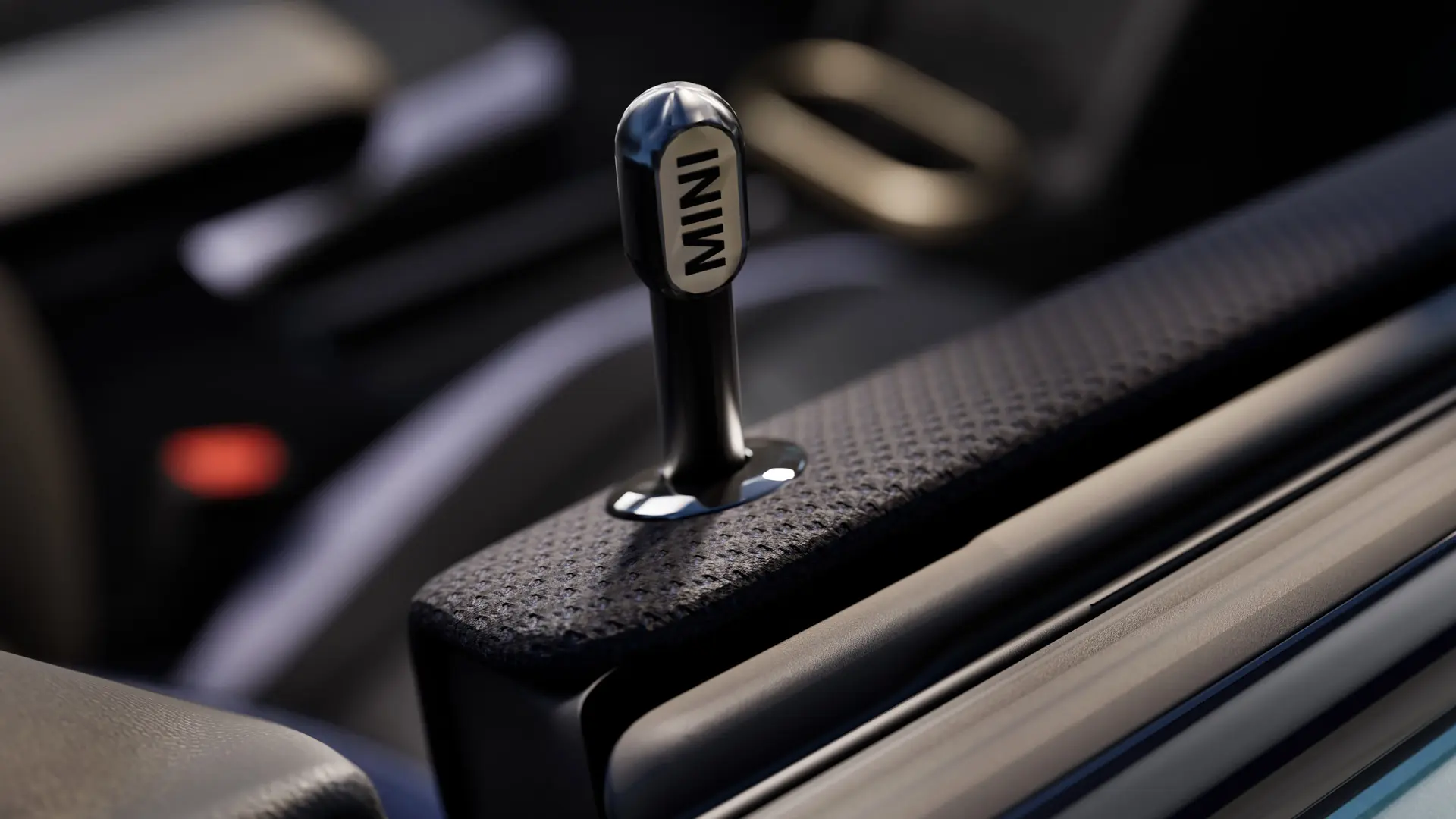 Κοντινό πλάνο του γνήσιου πείρου ασφάλισης εσωτερικής πόρτας MINI σε μαύρο ανοδιωμένο αλουμίνιο.