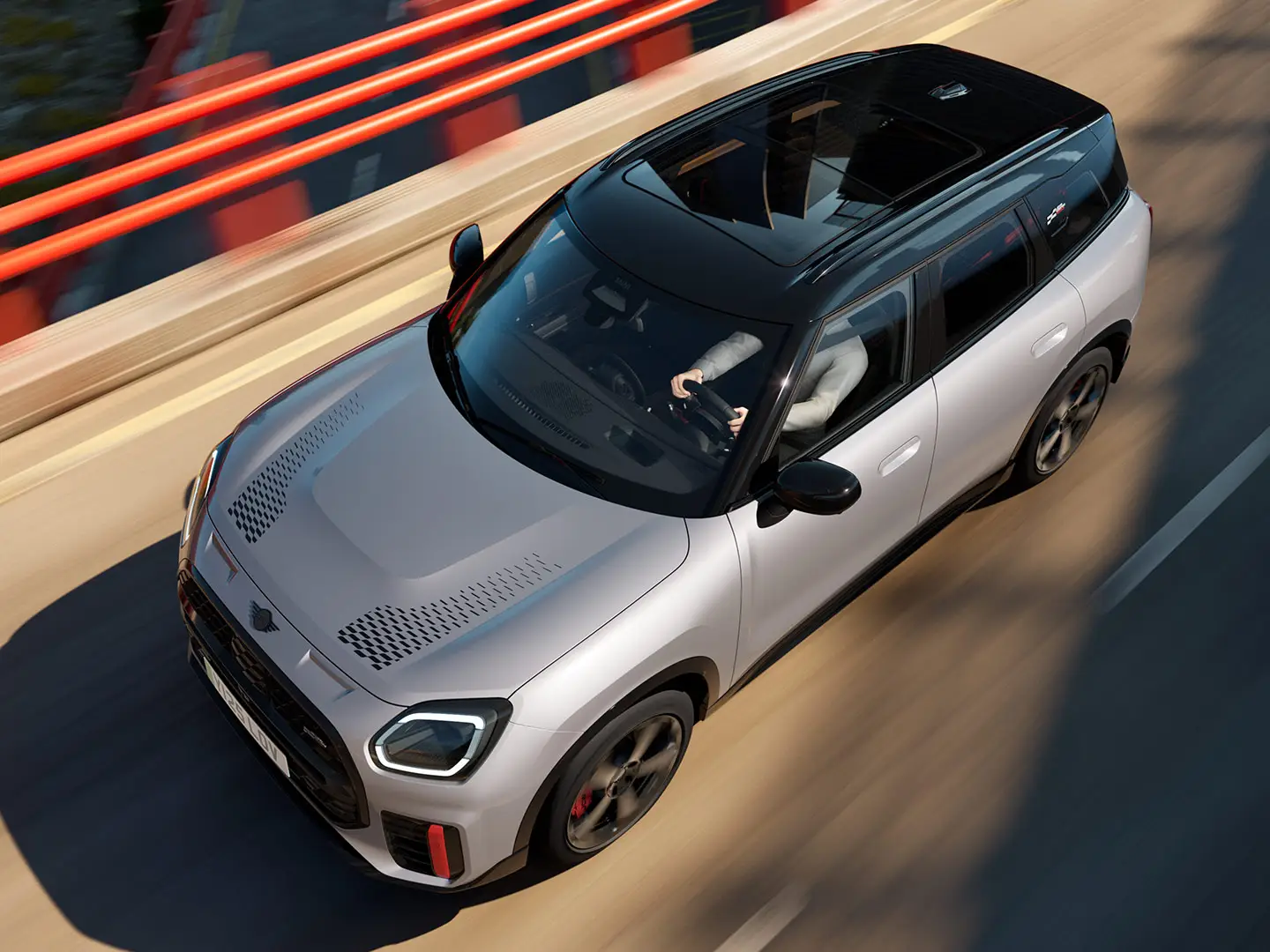 MINI Countryman John Cooper Works σε Melting Silver με μαύρη οροφή, όπου απεικονίζεται ο βασικός εξοπλισμός - μπροστινή όψη από το πλάι.