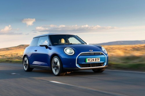 MINI Cooper 3-Door driving on the road with iconic design and electric performance